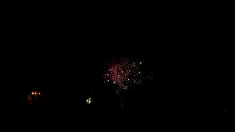 Colorful festive fireworks explode against the black sky. Stock Footage 344751256