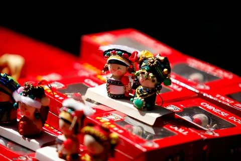 Colorful figurines atop red rectangular boxes, isolated on a black background 스톡 사진