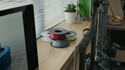 Colorful Filament Spools, Computer Screen and 3D Printer in Modern Classroom Stock Footage 301909942