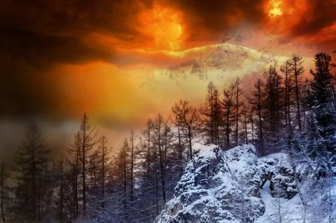 Colorful fire storm dramatic sky in the snow mountain. Mountain landscape. Dr 스톡 사진