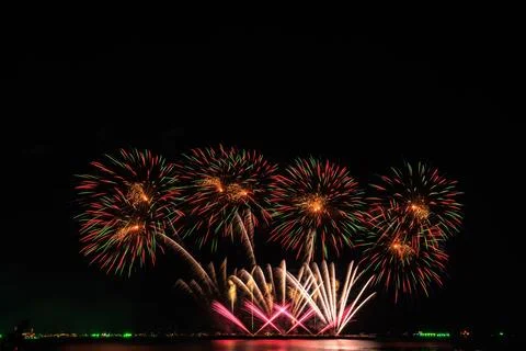 Colorful Firework Display Exploding Over Tranquil Water Horizon Night Landsca Foto stock