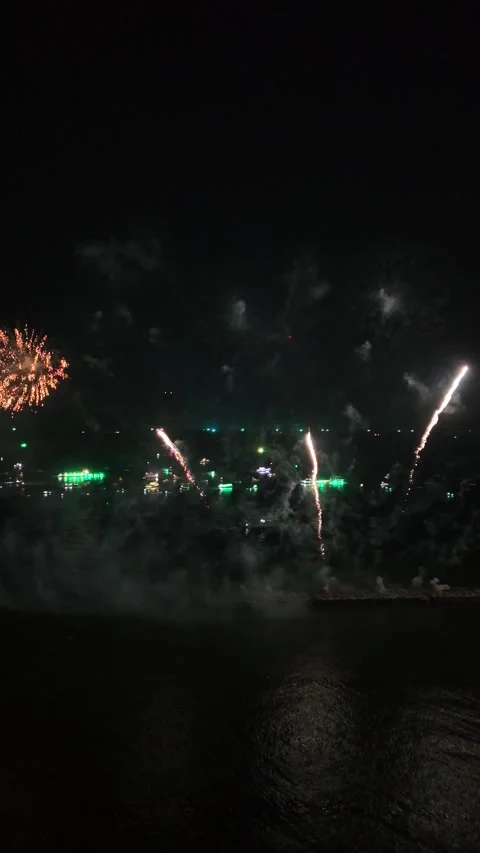 Colorful Fireworks Display Exploding Over Water at Night in Pattaya, Thailand Stock Footage 335842918