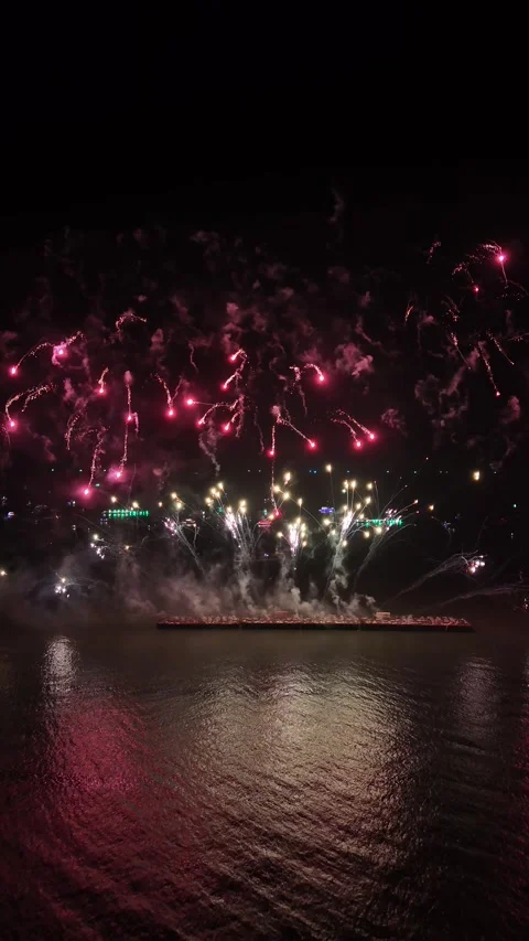 Colorful Fireworks Display Exploding Over Water at Night in Pattaya, Thailand Stock Footage 335843383