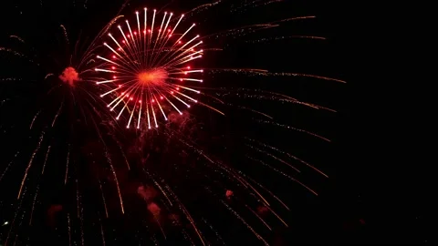 Colorful fireworks explode and sparkle in the black night sky, slow motion Stock Footage 148081778