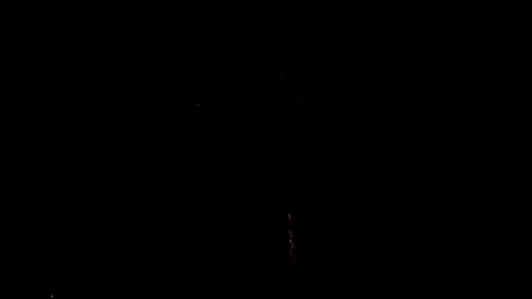 Colorful fireworks explode in the dark night sky beautifully Stock Footage 329673722
