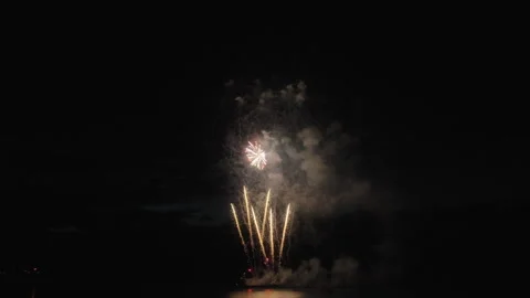 Colorful fireworks exploding above the lake. Slow motion Video stock 319803870