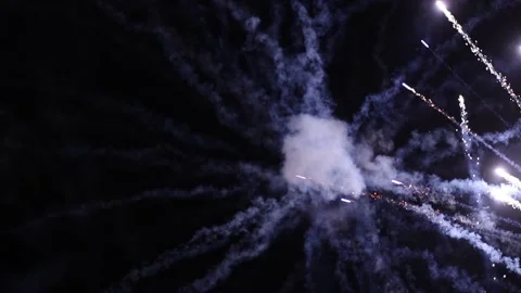 Colorful fireworks exploding in the air at night and leaving the smoke tracks Stock Footage 133026608
