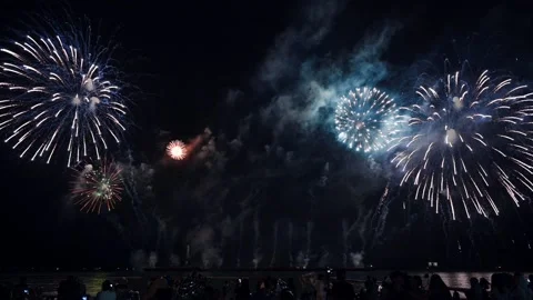 Colorful fireworks exploding with audience watching show in annual festival Stock Footage 163810305