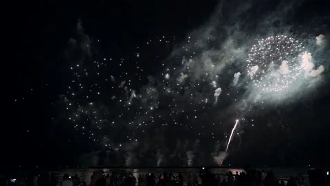 Colorful fireworks exploding with audience watching show in annual festival Stock Footage 163810485
