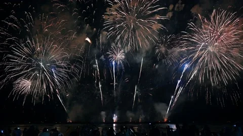 Colorful fireworks exploding with audience watching show in annual festival Stock Footage 163810488