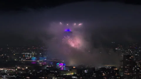Colorful fireworks exploding in cloud at night, Fireworks at observation tower Stock Footage 264985521