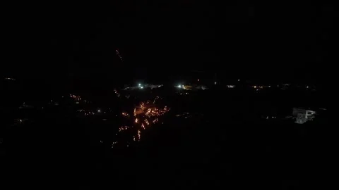 Colorful fireworks exploding in the dark sky over a tranquil balinese village 库存影片 331668094