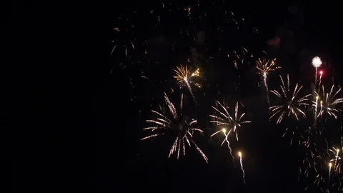 Colorful fireworks exploding in the night sky in busts of red, white and Stock Footage 112361547