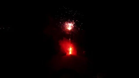 Colorful fireworks exploding in night sky with bright red sparkles 스톡 동영상 334656825