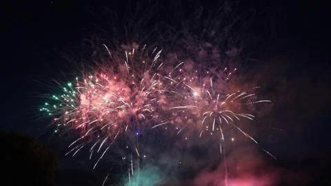 Colorful fireworks exploding in the night sky during a celebration Stock Photos
