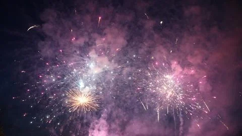 Colorful fireworks exploding in the night sky, creating a festive atmosphere Stock Photos