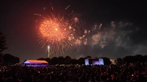 Colorful fireworks exploding over a crowd at a night outdoor event 库存影片 340941334