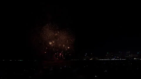 Colorful Fireworks Exploding Over Dark Sea Horizon And Coastal City Skyline.. Stockbeeldmateriaal 340182845