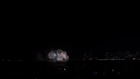 Colorful Fireworks Exploding Over The Ocean Coastline At Night In Pattaya T.. Stockbeeldmateriaal 339551205