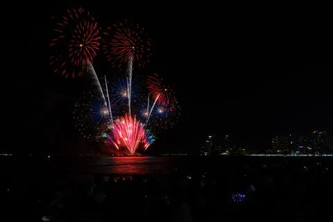 Colorful Fireworks Exploding Over The Ocean Night Sky In Pattaya City Thail.. Stock Photos