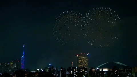 Colorful fireworks exploding in the sky of illuminated urban Fukuoka city. Stock Footage 78544475