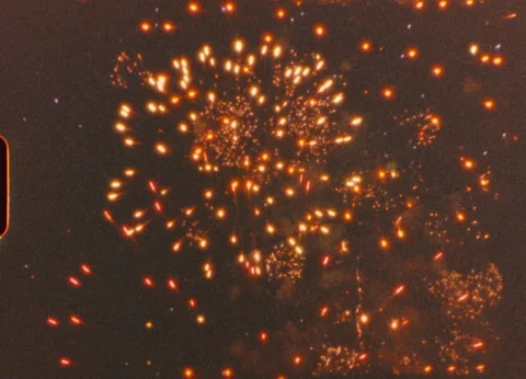 Colorful fireworks exploding, sparkling across night sky, revealing brilliant Video stock 306662094