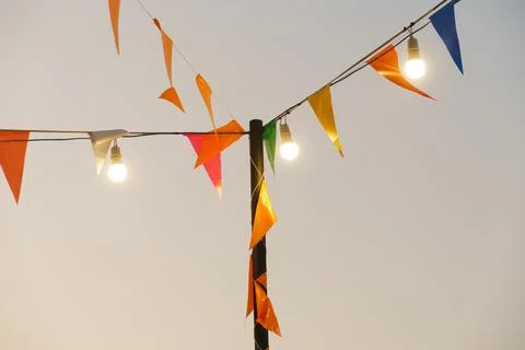 Colorful flags and lights create festive atmosphere in sky Stock Photos