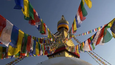 Colorful flags with Buddhist scriptures on a stupa in Nepal. UHD 4K Stock Footage 103430014