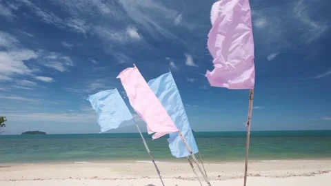 Colorful flags flapping in the wind on a white sand tropical beach in Thailand Video stock 188682251