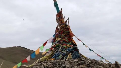 Colorful Flags Fluttering on Wind Above Ovoo Stones in Mongolian Steppe Video stock 348046989