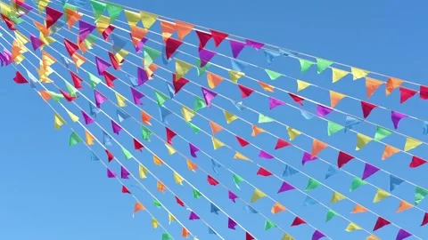 Colorful flags hanging on the background of blue sky as festive decorations for Stock Footage 276291209