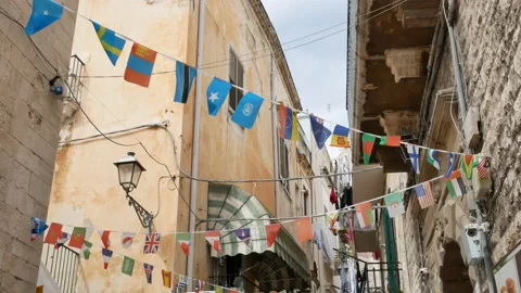 Colorful flags in the old town in Bari in Italy Stock Footage 150081788