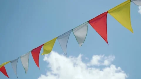 Colorful flags under blue sky in windy day at slow motion Stock Footage 226906376