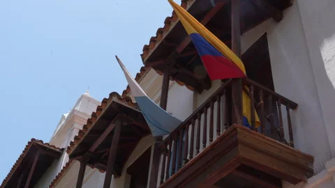 Colorful Flags Waving at Santa Marta Museo del Oro Colonial Balcony in Sunlight Stock Footage 343036983