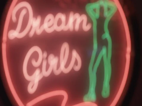 A colorful flashing and neon sing Dream Girls at night street in Maui, Thailand Stock Footage