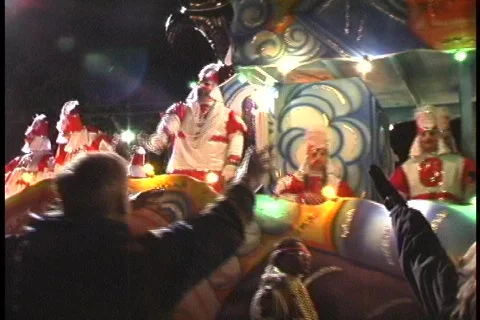 A colorful float passes by a crowd of people during a Mardi Gras parade in New Stock Footage 438222