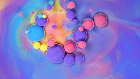 Colorful floating paint bubbles create mesmerizing patterns in a swirling Stock Footage 288125484