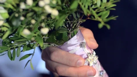 Colorful flowers in a man's hand, a man in a dark suit holding a bouquet of Stock Footage