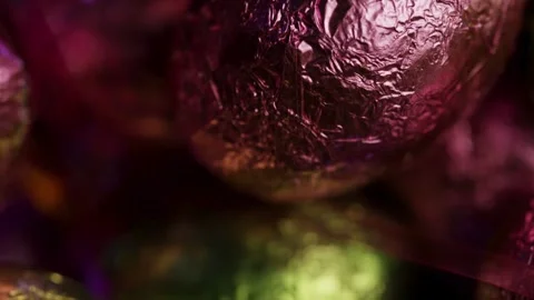 Colorful foil wrapped chocolate Easter eggs rotating macro shot Stock Footage 328074245