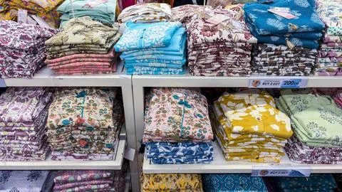 Colorful folded cotton kurta stack display in retail store with floral prin.. 스톡 사진