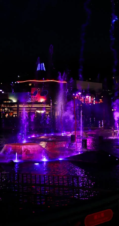 Colorful Fountains and Fireworks Exploding at Night City Water Show Stock Footage 327690418