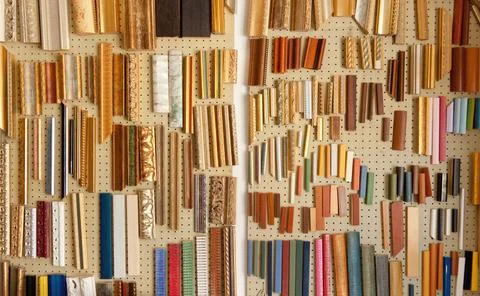 Colorful frame samples hanging on a pegboard in a carpentry workshop Stock Photos
