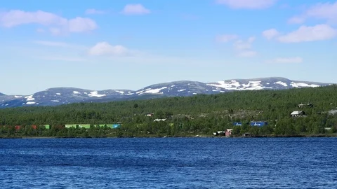 Colorful freight train passing along the distant shore of a beautiful lake. Stock Footage 116363371