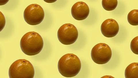 Colorful fruit pattern of fresh grapefruits on yellow background with shadows Stock Footage 167487168