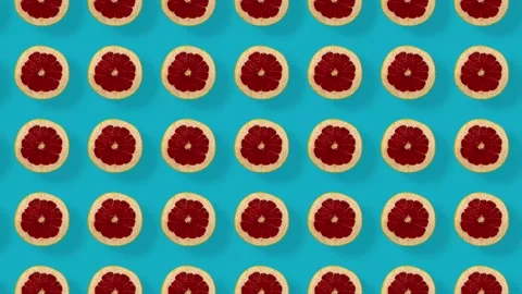Colorful fruit pattern of fresh grapefruits on blue background with shadows Stock Footage 167488314