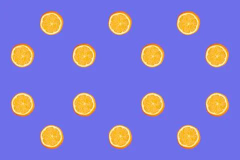 Colorful fruit pattern of fresh lemon slices on blue background. From top view Stock Photos