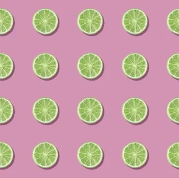 Colorful fruit pattern of fresh lime slices on pink background. Stock Photos