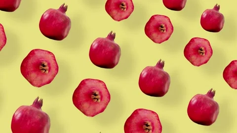 Colorful fruit pattern of fresh red pomegranates on yellow background with Video stock 167479292