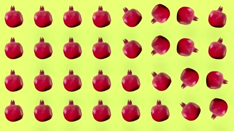 Colorful fruit pattern of fresh red pomegranates on yellow background. Seamless Stock Footage 167486004