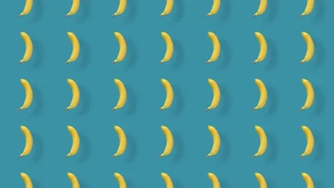 Colorful fruit pattern of fresh yellow bananas on blue background with shadows Stock Footage 167486241